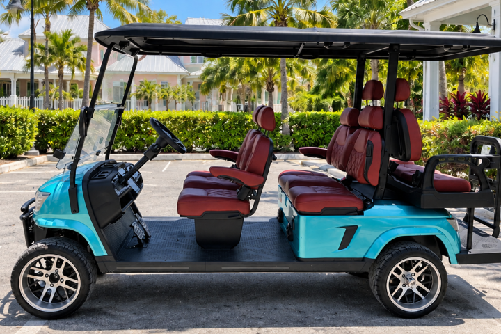 Blue golf cart with red seats parked in lot, surrounded by palm trees.